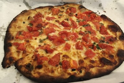A fresh tomato pie from Pepe's, a favorite pizza place of Corsair, apartments in New Haven, Connecticut